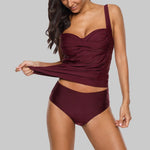 Load image into Gallery viewer, Woman wearing a burgundy swimsuit on a gray background

