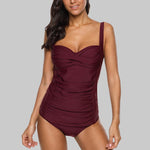 Load image into Gallery viewer, Woman wearing a burgundy swimsuit against a gray background
