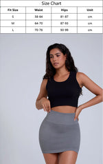 Load image into Gallery viewer, Woman wearing a black crop top and gray skirt with a size chart overlay on a white background
