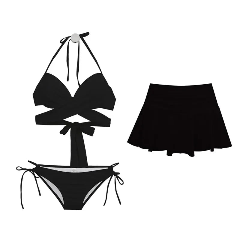 Black bikini set with a matching skirt on a white background