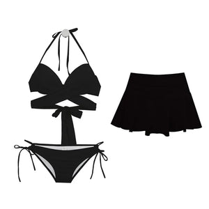 Black bikini set with a matching skirt on a white background