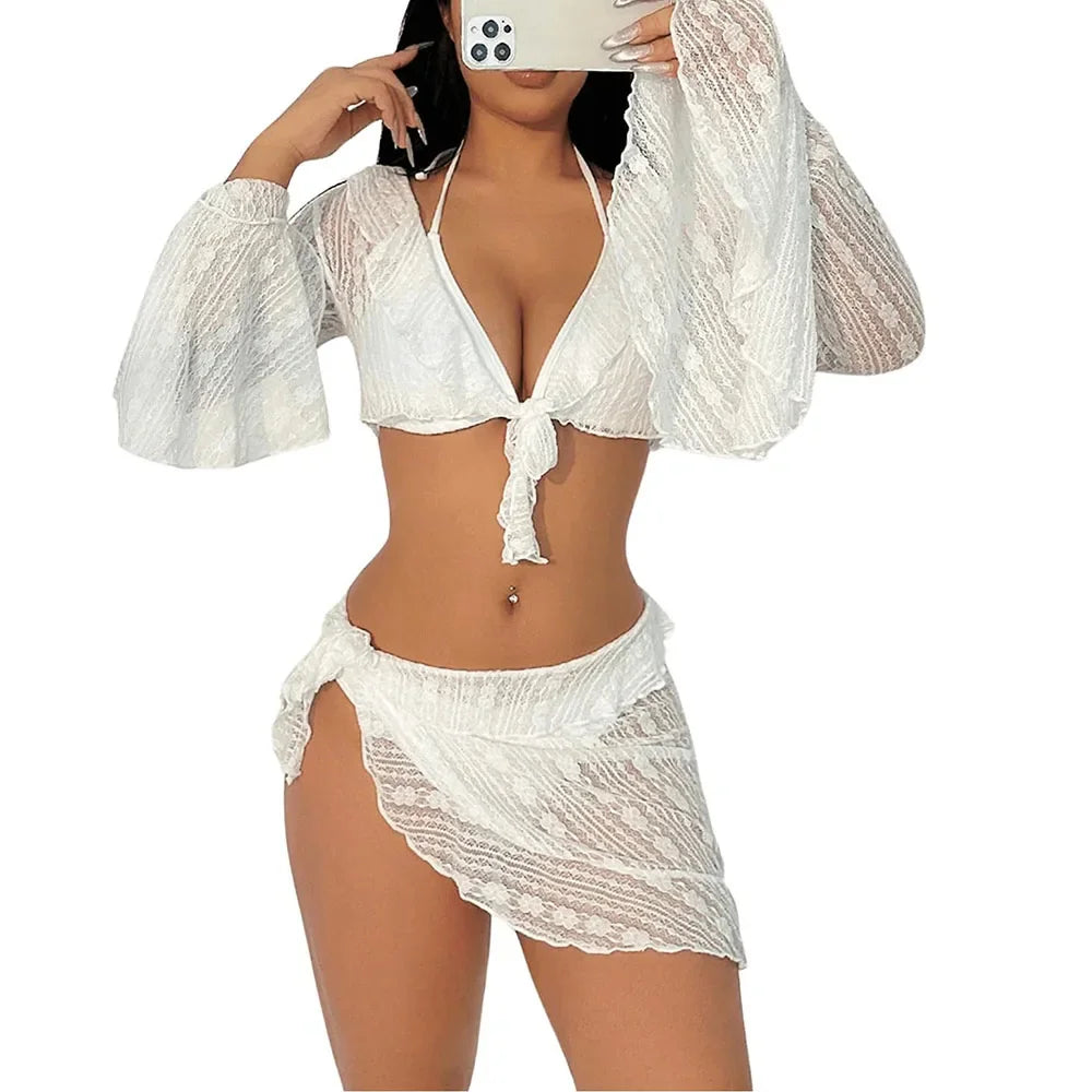 Woman wearing a white lace bikini set with a matching cover-up on a white background