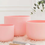 Load image into Gallery viewer, Set of three pink planters on a textured surface with a blurred background
