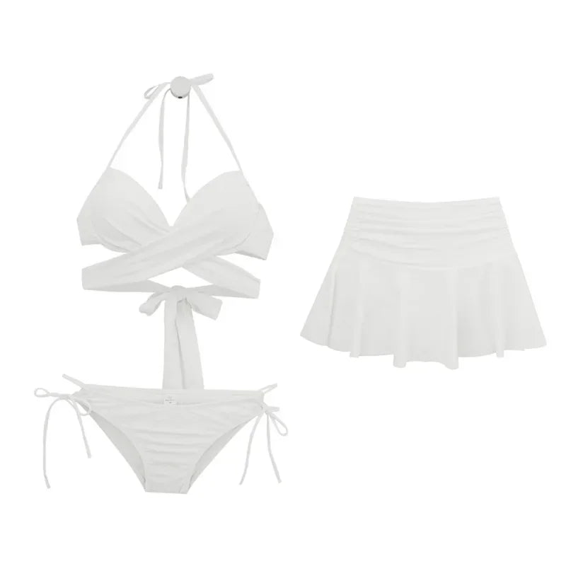 White bikini set with matching skirt on a white background