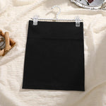 Load image into Gallery viewer, Black skirt on a hanger against a textured white background

