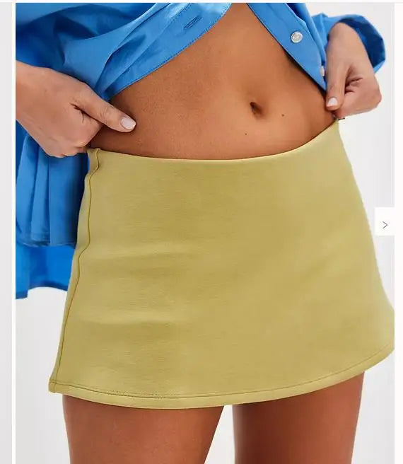 Person wearing a blue shirt and yellow skirt on a white background
