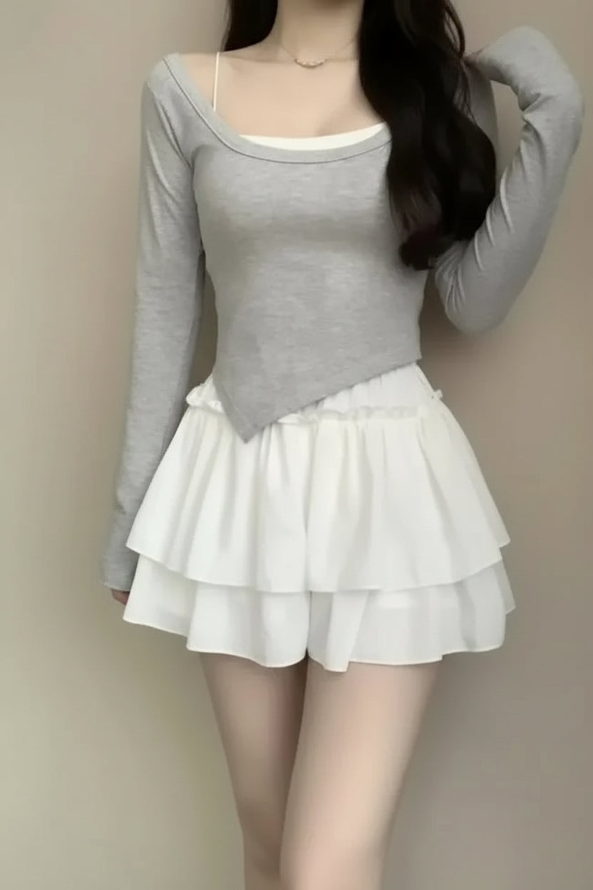 Person wearing a white skirt against a plain background