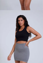 Load image into Gallery viewer, Woman wearing a black crop top and gray skirt on a light gray background
