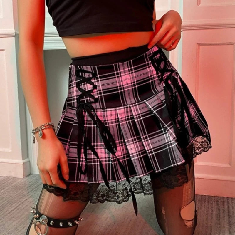 Person wearing a plaid skirt with lace details in a room.
