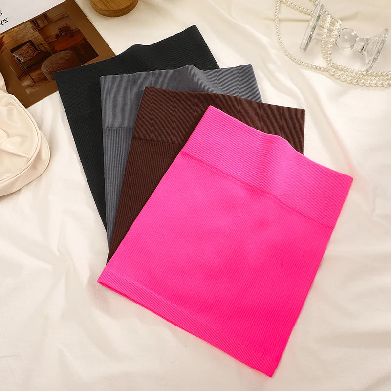 Four colorful fabric samples on a white surface